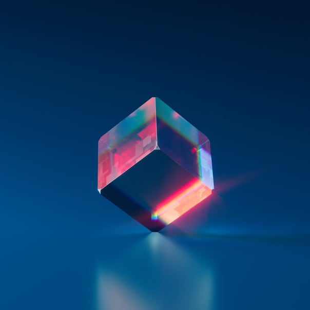 A transparent cube balanced in one of its corners in a dark blue background promoting balance and calm